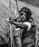 Men Dani tribe shoot an arrow.